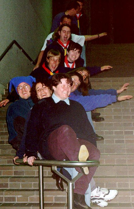 Thumbnail of a photo of a lot of people sliding down a banister all at once.