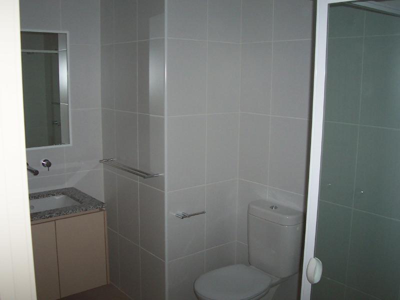 Bathroom with Marble finish and glass shower screen.