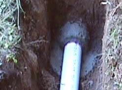 stormwtr3.jpg - 19196 Bytes - The Concrete sealing the pvc into the old concrete pipe.